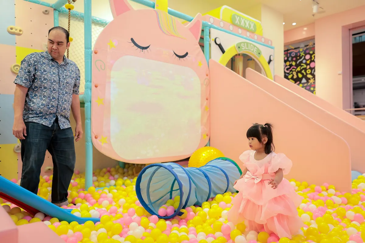 Children playing on the slide and ball pit at Lulu